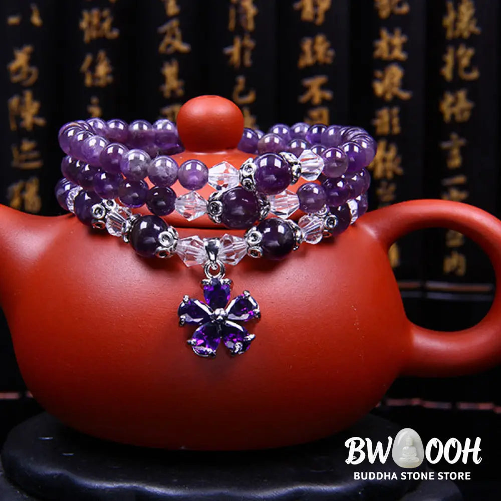 A close-up of the BWOOOH handcrafted Tibetan Amethyst Blessing Bracelet featuring lustrous 6mm natural purple amethyst beads and silver-plated copper accents, symbolizing spiritual protection and inner peace. - View 4