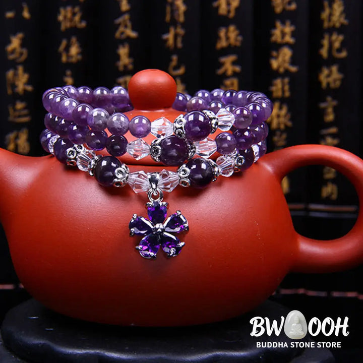 A close-up of the BWOOOH handcrafted Tibetan Amethyst Blessing Bracelet featuring lustrous 6mm natural purple amethyst beads and silver-plated copper accents, symbolizing spiritual protection and inner peace. - View 4