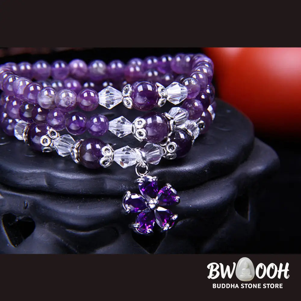 A close-up of the BWOOOH handcrafted Tibetan Amethyst Blessing Bracelet featuring lustrous 6mm natural purple amethyst beads and silver-plated copper accents, symbolizing spiritual protection and inner peace. - View 2