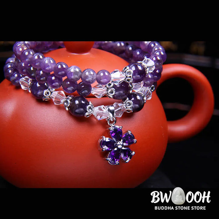A close-up of the BWOOOH handcrafted Tibetan Amethyst Blessing Bracelet featuring lustrous 6mm natural purple amethyst beads and silver-plated copper accents, symbolizing spiritual protection and inner peace. - View 5