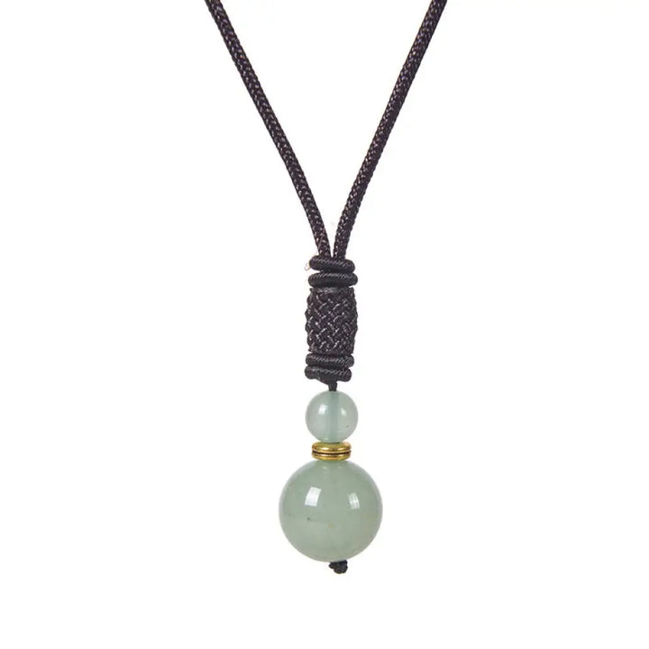A BWOOOH Tibetan Jade Harmony Necklace, 70cm in length, featuring polished 8mm and 16mm beads of Tiger Eye, Obsidian, Amethyst, Pink Crystal, Jade, and Malachite, designed for spiritual protection and inner peace. - View 10