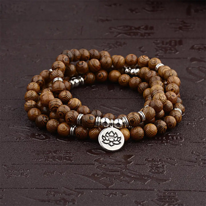A BWOOOH Tibetan Lightning Strike Wood Mala Bracelet, 46cm circumference, featuring distinct lightning bolt markings, accented with a silver-colored Lotus symbol and a peaceful Buddha charm.