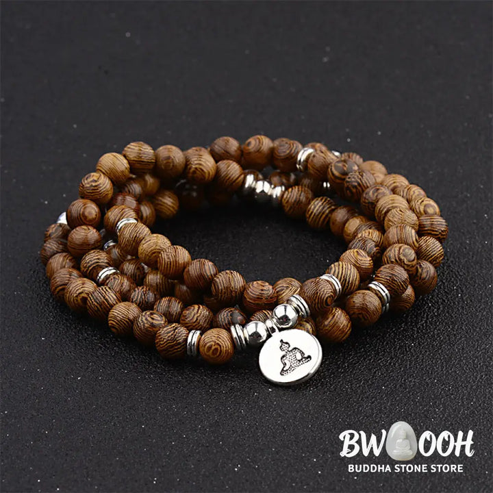 A BWOOOH Tibetan Lightning Strike Wood Mala Bracelet, 46cm circumference, featuring distinct lightning bolt markings, accented with a silver-colored Lotus symbol and a peaceful Buddha charm. - View 4