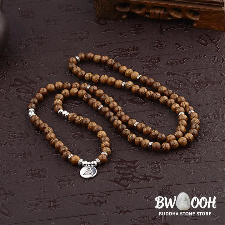 A BWOOOH Tibetan Lightning Strike Wood Mala Bracelet, 46cm circumference, featuring distinct lightning bolt markings, accented with a silver-colored Lotus symbol and a peaceful Buddha charm. - View 3
