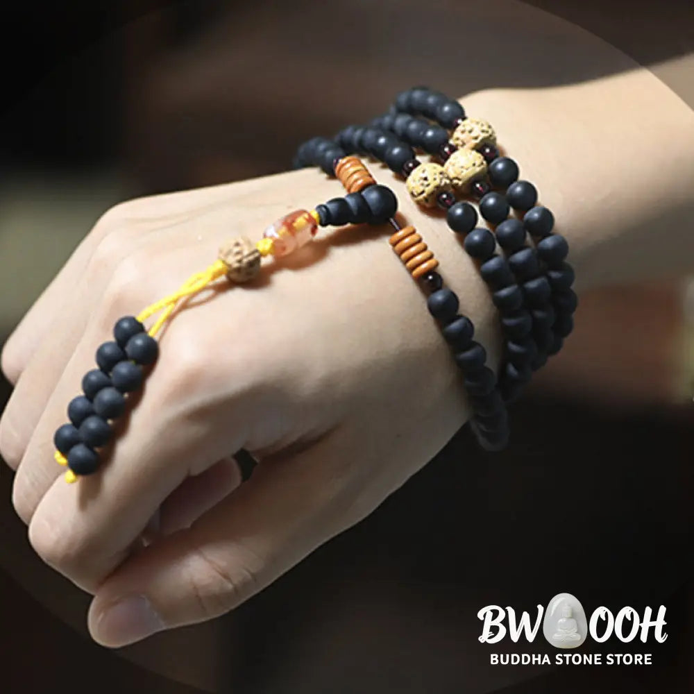 BWOOOH authentic Tibetan Mala bracelet or necklace crafted with 108 polished Cypress beads, distinctive dark-speckled Bodhi Seeds, vibrant Red Agate, and deep Garnet accents, embodying spiritual protection and healing energy. - View 4