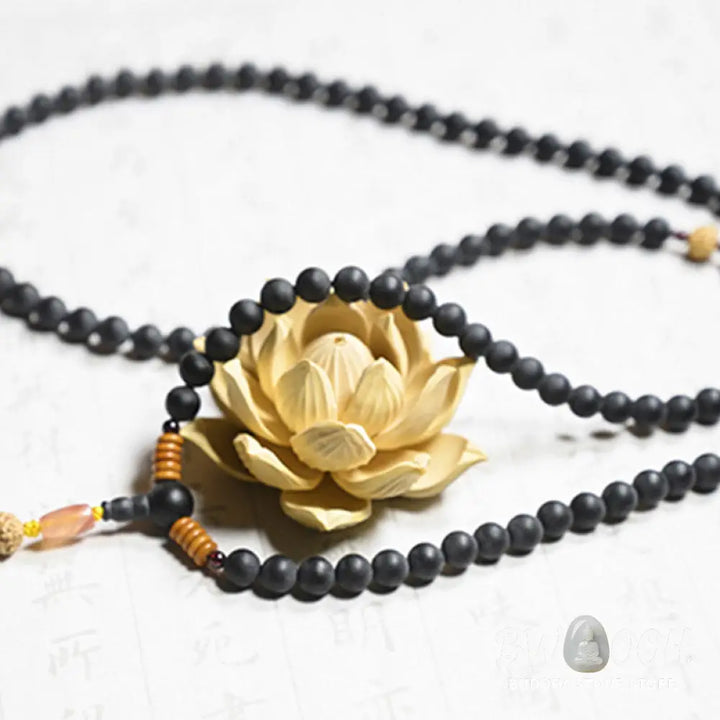 BWOOOH authentic Tibetan Mala bracelet or necklace crafted with 108 polished Cypress beads, distinctive dark-speckled Bodhi Seeds, vibrant Red Agate, and deep Garnet accents, embodying spiritual protection and healing energy. - View 9