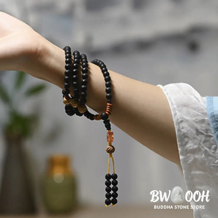 BWOOOH authentic Tibetan Mala bracelet or necklace crafted with 108 polished Cypress beads, distinctive dark-speckled Bodhi Seeds, vibrant Red Agate, and deep Garnet accents, embodying spiritual protection and healing energy. - View 7