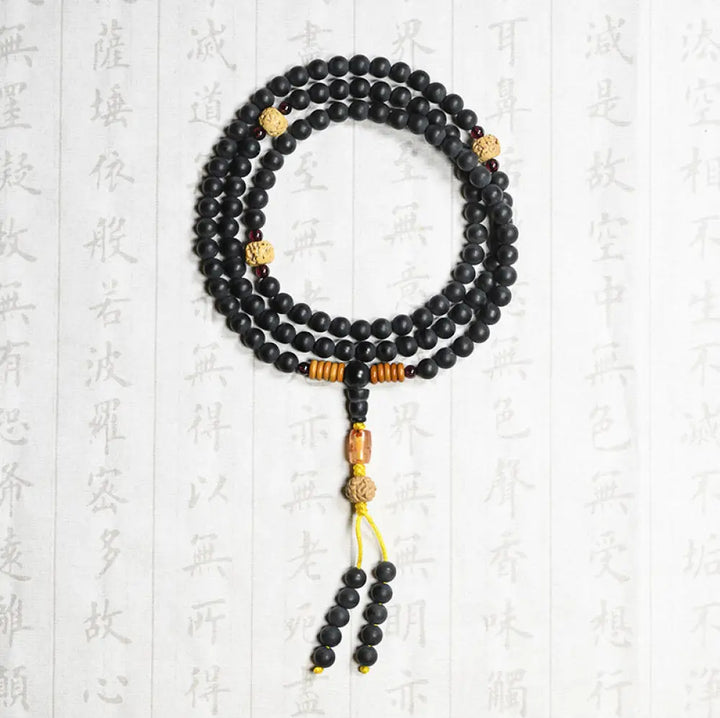 BWOOOH authentic Tibetan Mala bracelet or necklace crafted with 108 polished Cypress beads, distinctive dark-speckled Bodhi Seeds, vibrant Red Agate, and deep Garnet accents, embodying spiritual protection and healing energy. - View 3