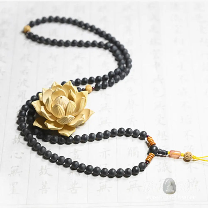BWOOOH authentic Tibetan Mala bracelet or necklace crafted with 108 polished Cypress beads, distinctive dark-speckled Bodhi Seeds, vibrant Red Agate, and deep Garnet accents, embodying spiritual protection and healing energy. - View 2
