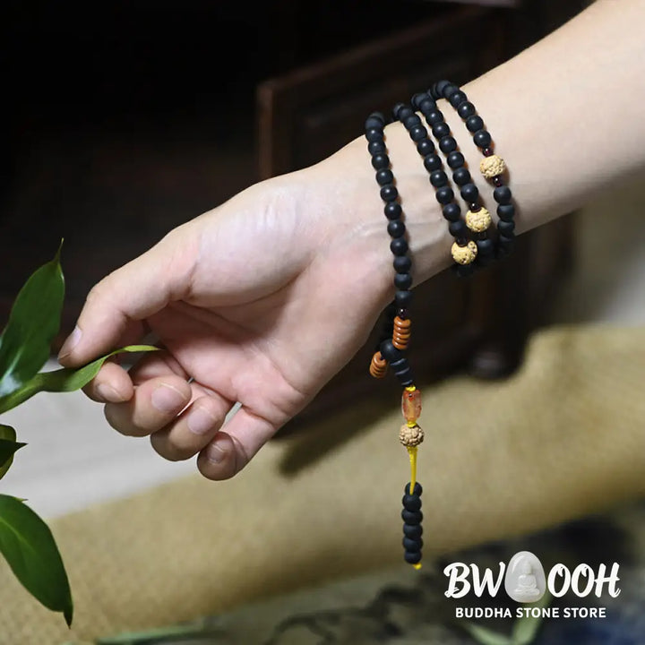 BWOOOH authentic Tibetan Mala bracelet or necklace crafted with 108 polished Cypress beads, distinctive dark-speckled Bodhi Seeds, vibrant Red Agate, and deep Garnet accents, embodying spiritual protection and healing energy. - View 5