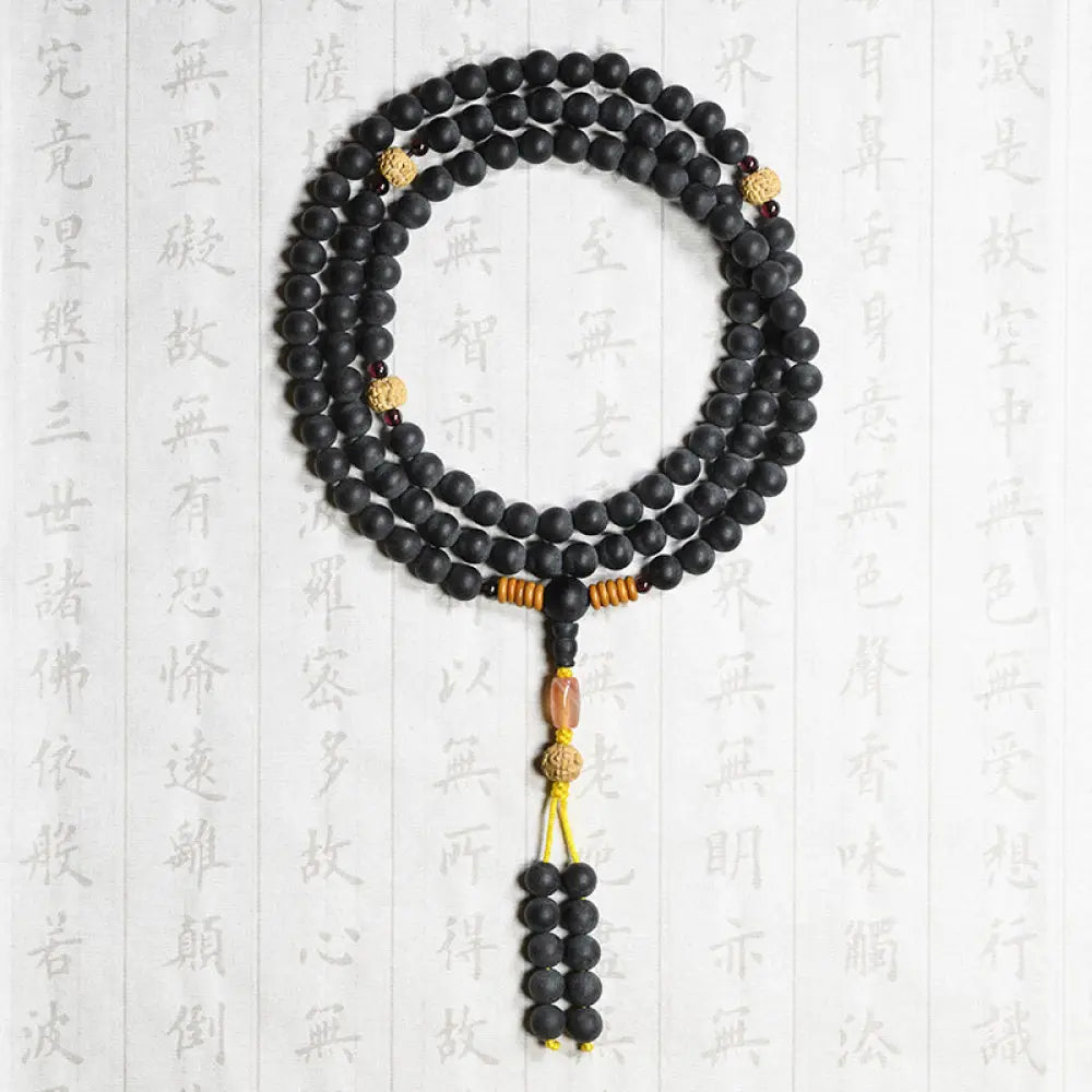BWOOOH authentic Tibetan Mala bracelet or necklace crafted with 108 polished Cypress beads, distinctive dark-speckled Bodhi Seeds, vibrant Red Agate, and deep Garnet accents, embodying spiritual protection and healing energy. - View 6