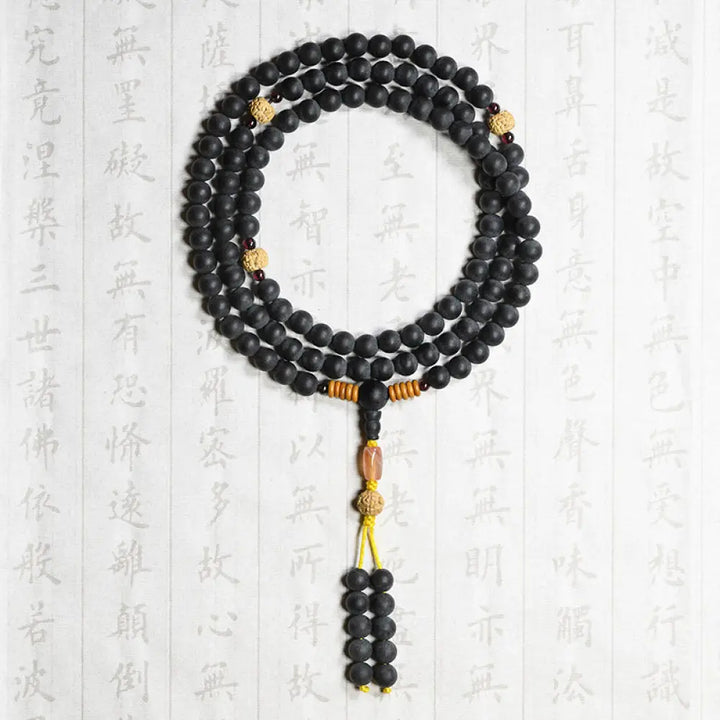 BWOOOH authentic Tibetan Mala bracelet or necklace crafted with 108 polished Cypress beads, distinctive dark-speckled Bodhi Seeds, vibrant Red Agate, and deep Garnet accents, embodying spiritual protection and healing energy. - View 6