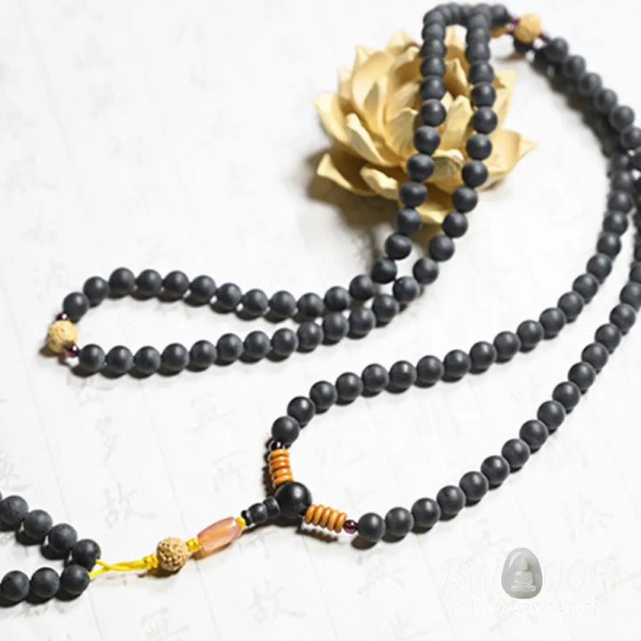 BWOOOH authentic Tibetan Mala bracelet or necklace crafted with 108 polished Cypress beads, distinctive dark-speckled Bodhi Seeds, vibrant Red Agate, and deep Garnet accents, embodying spiritual protection and healing energy. - View 10
