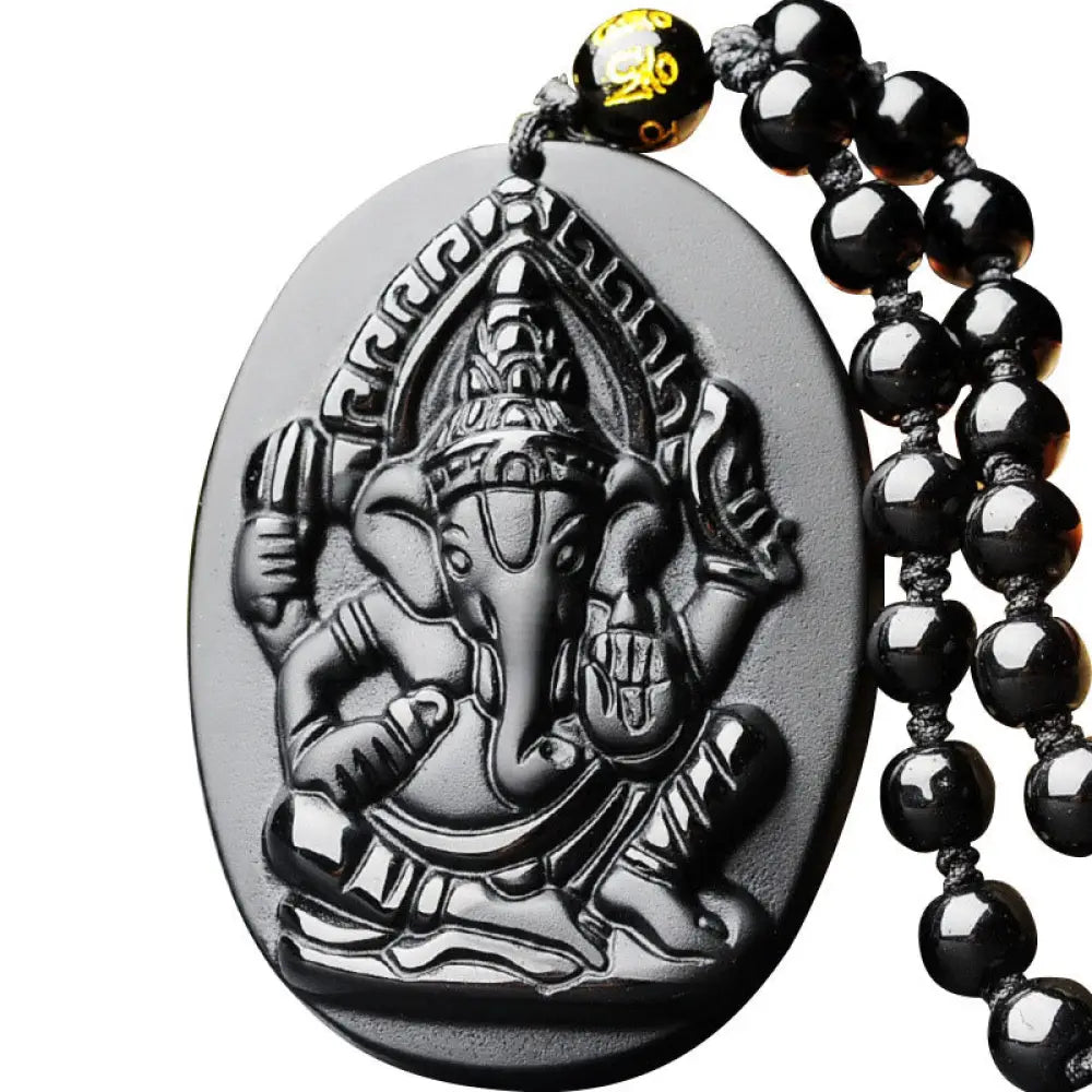 BWOOOH Tibetan Obsidian Ganesh Amulet Necklace, 56cm. Hand-carved elephant Ganesh on natural obsidian, for spiritual protection, prosperity, and root chakra grounding.