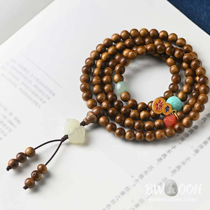 BWOOOH Tibetan Rosewood Protection Calm Bracelet Mala, 108 polished rosewood beads (6mm or 8mm) with red agate, green aventurine, turquoise, and jade accents, evoking protection and calm inspired by ancient Dzi traditions. - View 14