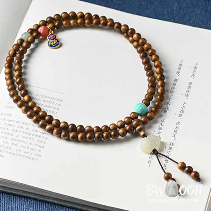 BWOOOH Tibetan Rosewood Protection Calm Bracelet Mala, 108 polished rosewood beads (6mm or 8mm) with red agate, green aventurine, turquoise, and jade accents, evoking protection and calm inspired by ancient Dzi traditions. - View 13