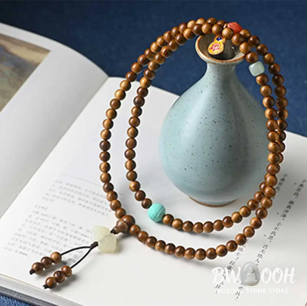 BWOOOH Tibetan Rosewood Protection Calm Bracelet Mala, 108 polished rosewood beads (6mm or 8mm) with red agate, green aventurine, turquoise, and jade accents, evoking protection and calm inspired by ancient Dzi traditions. - View 8