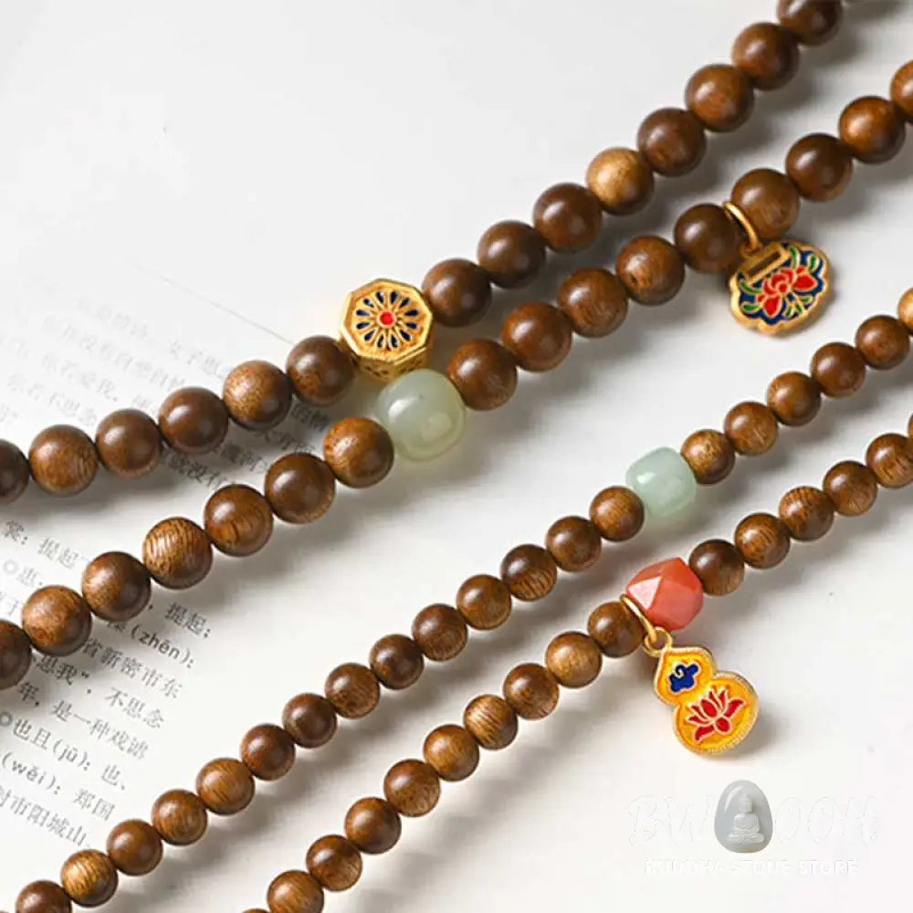 BWOOOH Tibetan Rosewood Protection Calm Bracelet Mala, 108 polished rosewood beads (6mm or 8mm) with red agate, green aventurine, turquoise, and jade accents, evoking protection and calm inspired by ancient Dzi traditions. - View 18