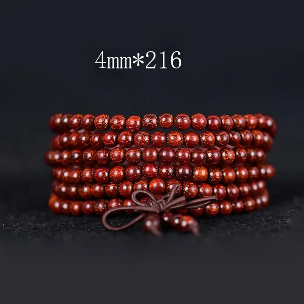 BWOOOH Tibetan Small Leaf Red Sandalwood Balance Bracelet, 108 beads, close-up. Polished dark red wood beads with subtle grain, evoking spiritual protection and calm. - View 7