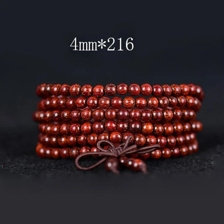 BWOOOH Tibetan Small Leaf Red Sandalwood Balance Bracelet, 108 beads, close-up. Polished dark red wood beads with subtle grain, evoking spiritual protection and calm. - View 7