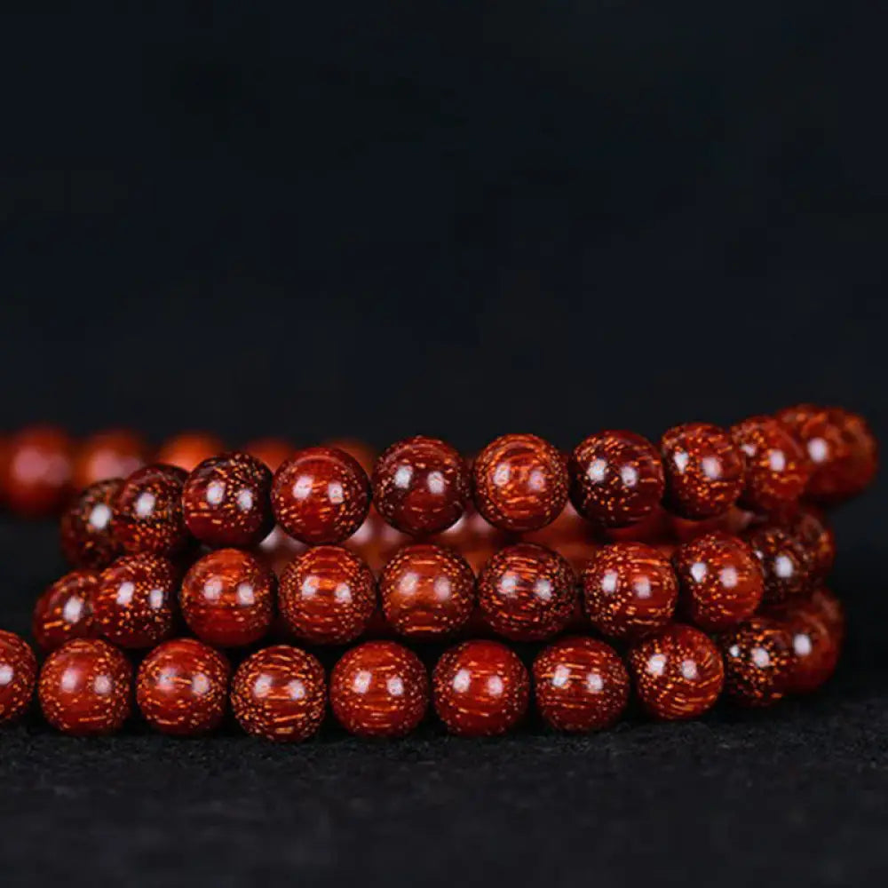 BWOOOH Tibetan Small Leaf Red Sandalwood Balance Bracelet, 108 beads, close-up. Polished dark red wood beads with subtle grain, evoking spiritual protection and calm. - View 13