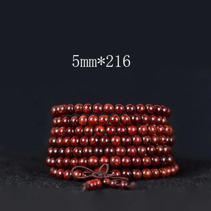 BWOOOH Tibetan Small Leaf Red Sandalwood Balance Bracelet, 108 beads, close-up. Polished dark red wood beads with subtle grain, evoking spiritual protection and calm. - View 8