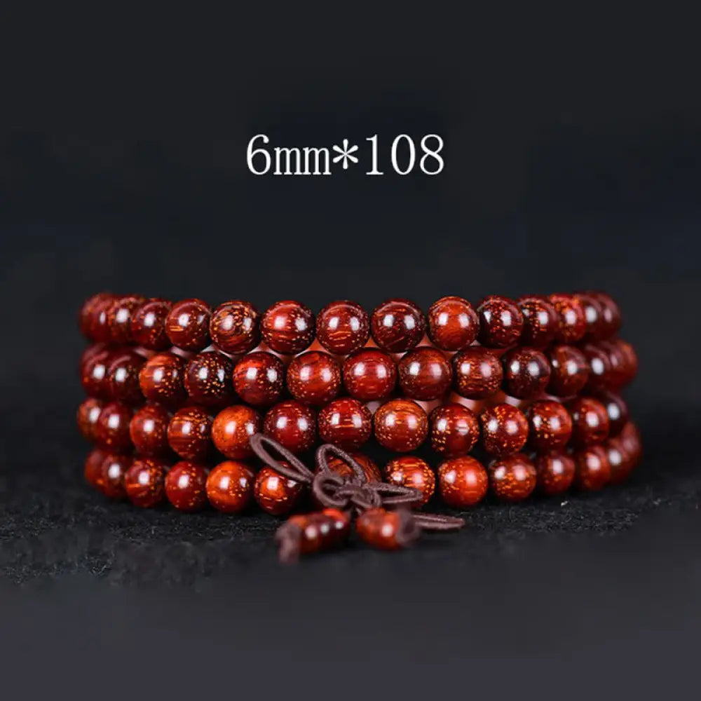 BWOOOH Tibetan Small Leaf Red Sandalwood Balance Bracelet, 108 beads, close-up. Polished dark red wood beads with subtle grain, evoking spiritual protection and calm. - View 2