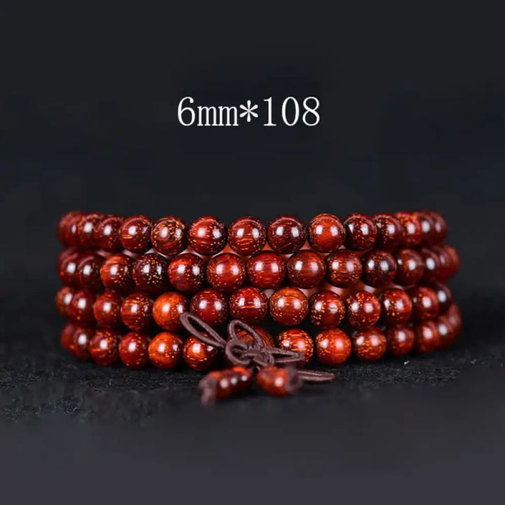 BWOOOH Tibetan Small Leaf Red Sandalwood Balance Bracelet, 108 beads, close-up. Polished dark red wood beads with subtle grain, evoking spiritual protection and calm. - View 2
