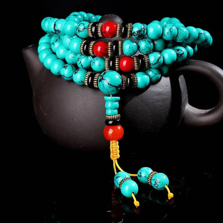 BWOOOH Tibetan Turquoise Healing Mala Bracelet with 108 polished 6mm/8mm Turquoise, Black Onyx, Red Agate, and Copper beads, featuring a Buddha charm. Sacred amulet for protection and inner peace.
