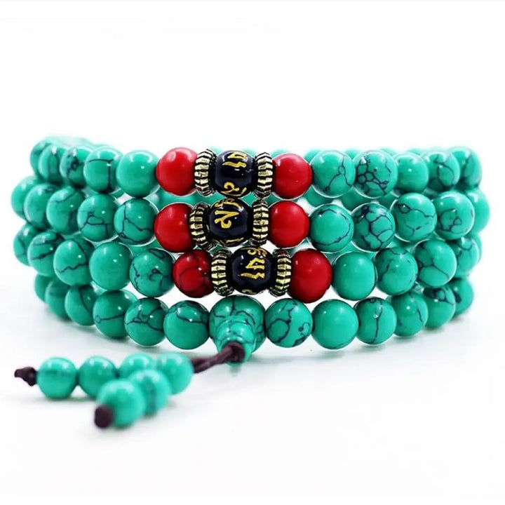 Close-up of a BWOOOH Tibetan Turquoise Purification Necklace Mala, featuring 8mm beads of vibrant blue turquoise, deep black onyx, rich red agate, and polished copper, strung as a 108-bead mala. The intricate details highlight its craftsmanship and spiritual significance.