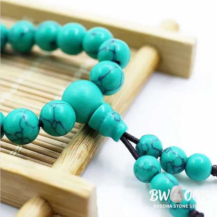 Close-up of a BWOOOH Tibetan Turquoise Purification Necklace Mala, featuring 8mm beads of vibrant blue turquoise, deep black onyx, rich red agate, and polished copper, strung as a 108-bead mala. The intricate details highlight its craftsmanship and spiritual significance. - View 4