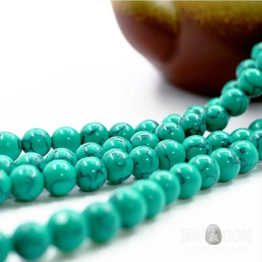 Close-up of a BWOOOH Tibetan Turquoise Purification Necklace Mala, featuring 8mm beads of vibrant blue turquoise, deep black onyx, rich red agate, and polished copper, strung as a 108-bead mala. The intricate details highlight its craftsmanship and spiritual significance. - View 5