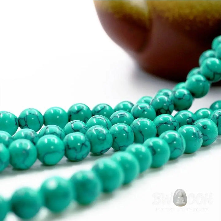 Close-up of a BWOOOH Tibetan Turquoise Purification Necklace Mala, featuring 8mm beads of vibrant blue turquoise, deep black onyx, rich red agate, and polished copper, strung as a 108-bead mala. The intricate details highlight its craftsmanship and spiritual significance. - View 5
