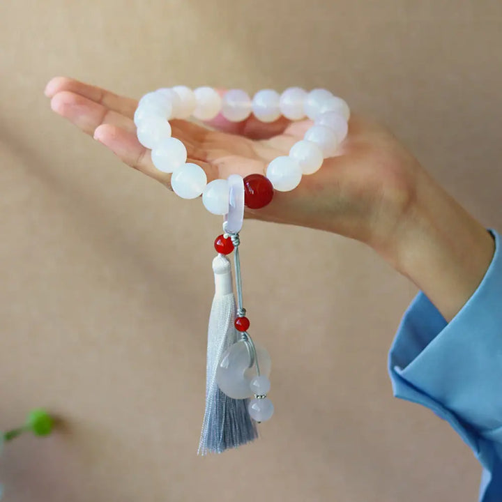 BWOOOH White Agate Red Agate Luck Wrist Mala with tassels, featuring 12mm-14mm beads, for meditation, pocket charm, or car decoration, symbolizing clarity, peace, and confidence. - View 3