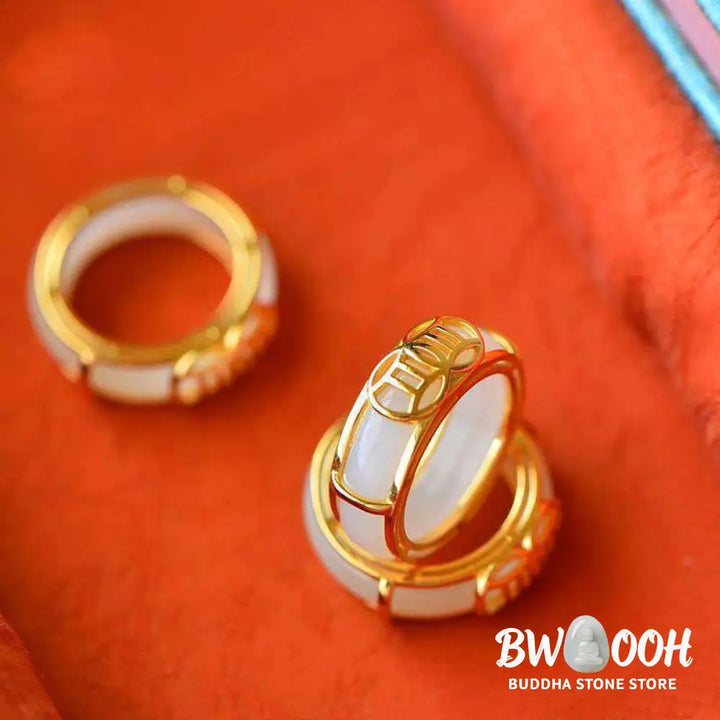 BWOOOH White Jade Luck Ring Necklace featuring a smooth white jade ring, intricately wrapped in copper wire with a prominent lucky knot symbol. The versatile piece is shown as a spiritual pendant on its included chain, suitable for unisex wear. - View 4