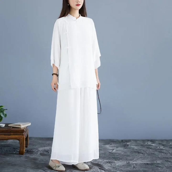 Woman wearing a white 3/4 sleeve frog-button Zen meditation set