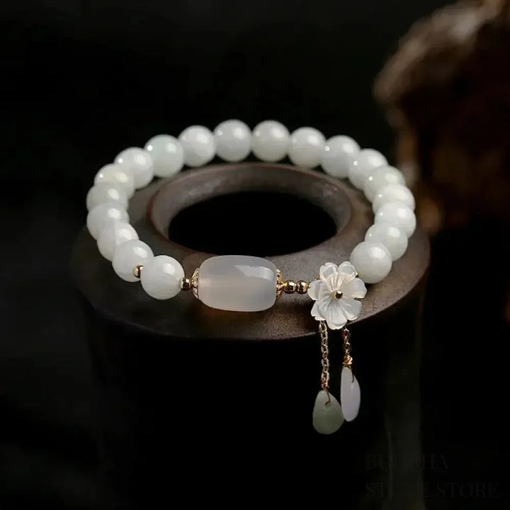 Close-up of BWOOOH Natural White Jade Luck Bracelet with 7.5mm polished beads on elastic string, symbolizing protection, enhanced clarity, and spiritual tranquility for daily wear.