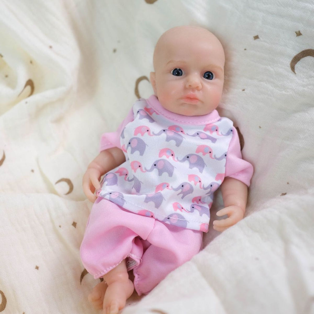 Luna 8-inch solid silicone baby doll, water-safe, with movable limbs and soft, lifelike features.