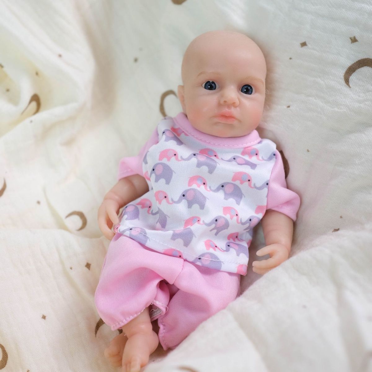 Luna 8-inch solid silicone baby doll, water-safe, with movable limbs and soft, lifelike features.