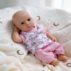 Luna 8-inch solid silicone baby doll, water-safe, with movable limbs and soft, lifelike features.