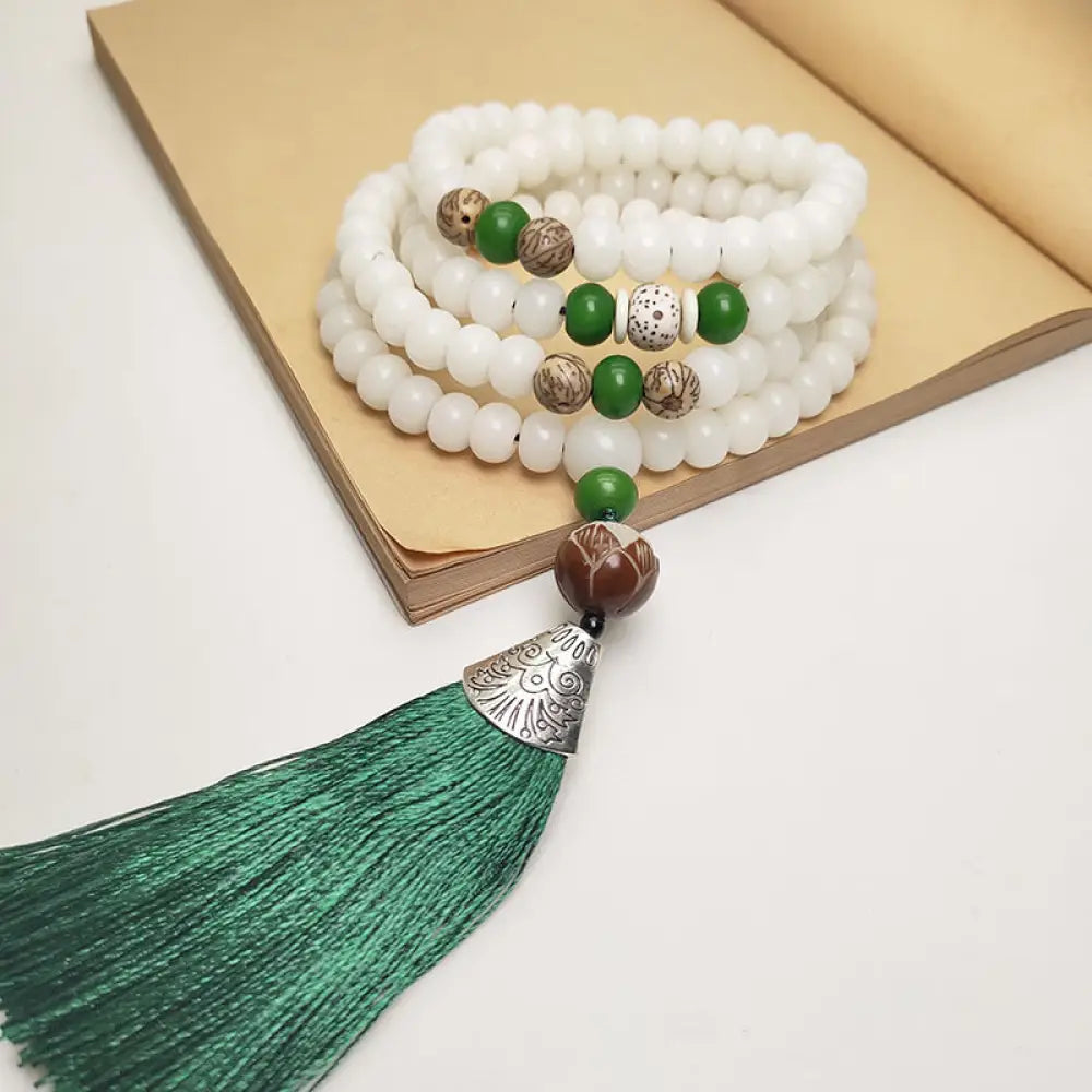 BWOOOH White Bodhi Seed Mala 108 beads bracelet, natural, unisex, displaying unique speckles and a smooth finish, ideal for meditation and spiritual protection.